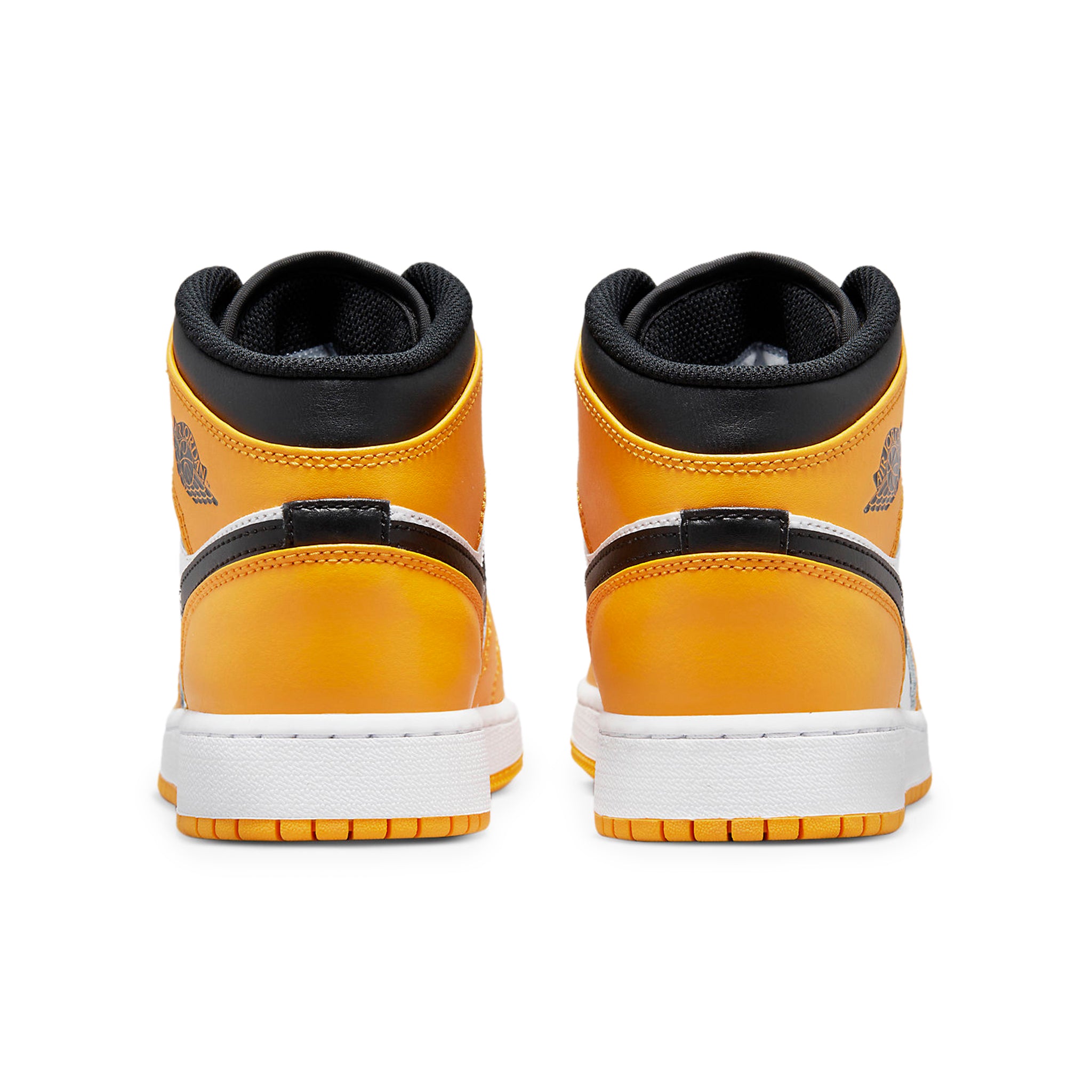 Heel view of Air Jordan 1 Mid Taxi (GS) 554725-701